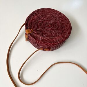 Round burgundy straw‎ basket bag with leather crossbody strap